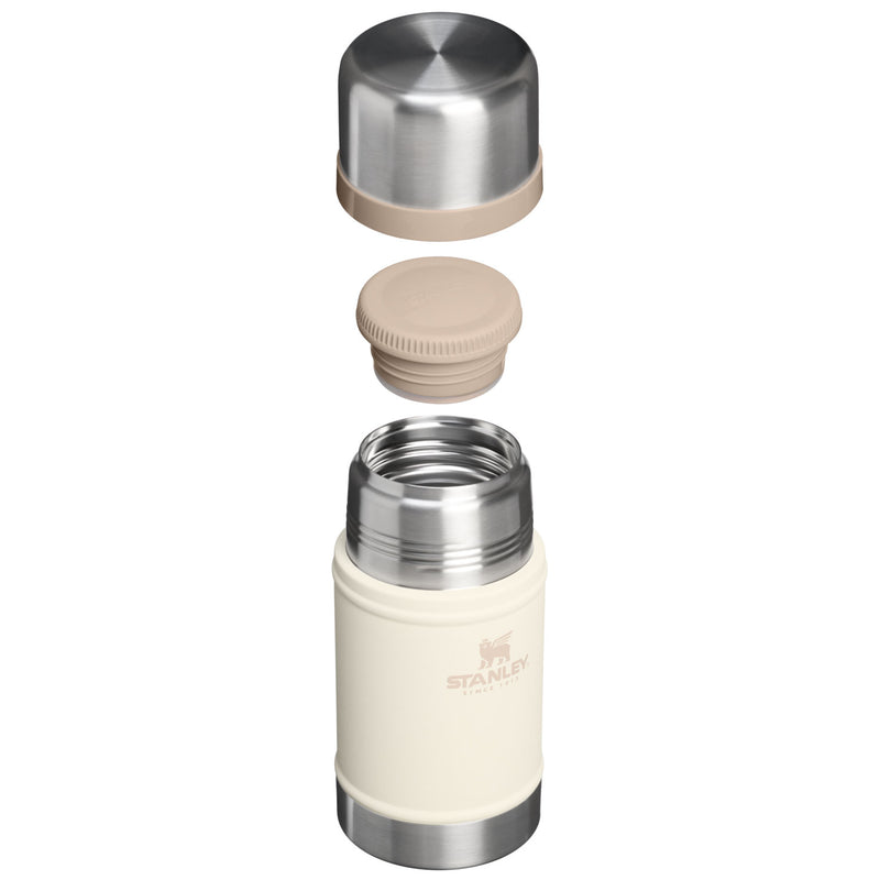 Load image into Gallery viewer, A stainless steel and cream vacuum-insulated bottle shown disassembled with its cap and lid floating above the main body on a white background. The Stanley logo is visible on the cream insulated body.