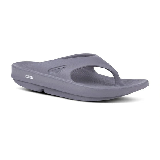 A slate Oofos OOriginal Thong flip flop sandal with a unique design, showing the brand logo on the arch support.