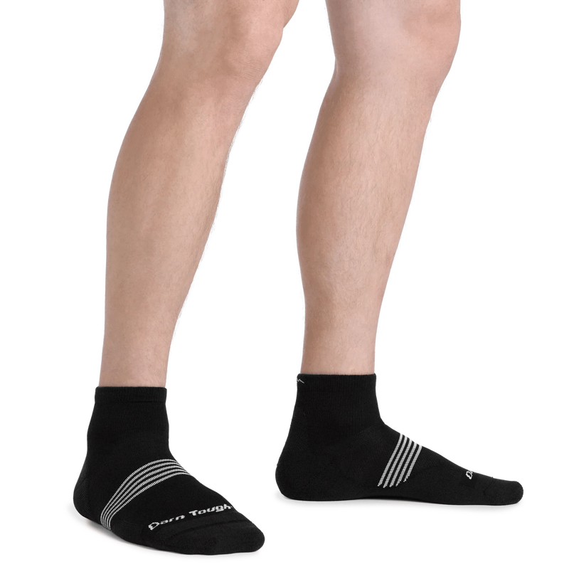 Load image into Gallery viewer, Black socks with white stripes worn by a person on a white background