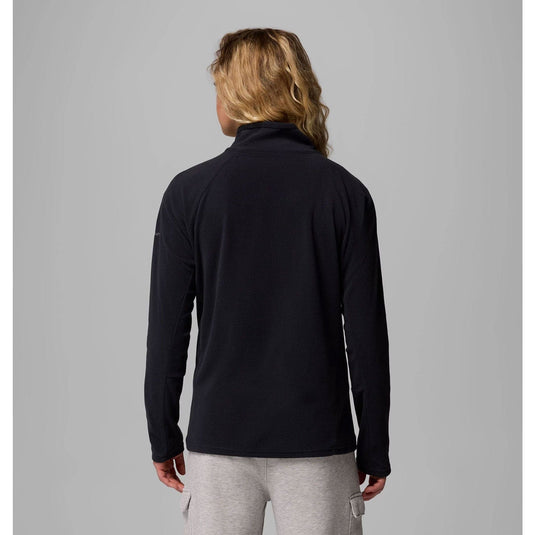 Person wearing a black long-sleeve shirt against a gray background