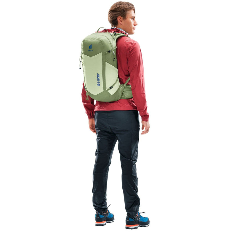 Load image into Gallery viewer, Person wearing a green backpack with a visible brand logo on a white background