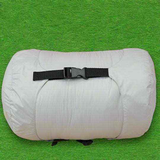 Load image into Gallery viewer, Sleeping Bag Grey with compression sack on green grass