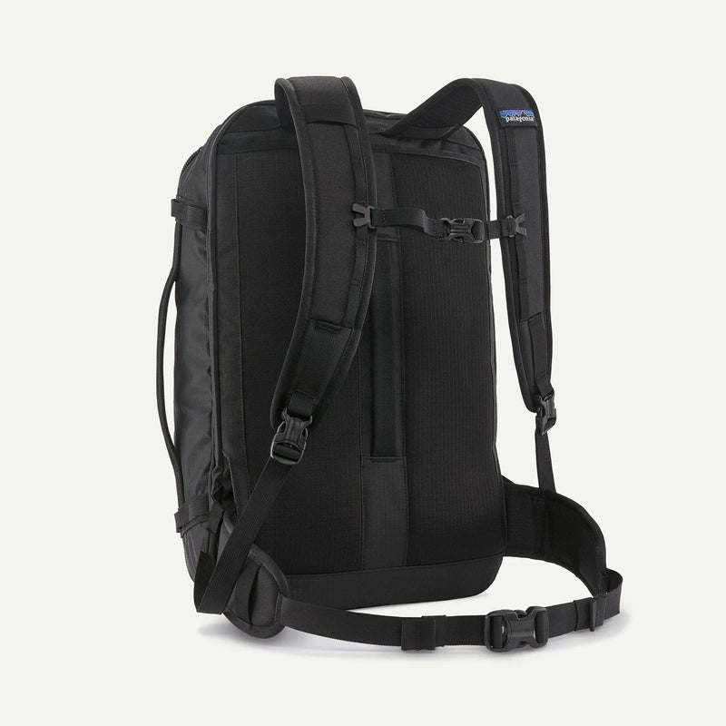 Load image into Gallery viewer, Black backpack with Patagonia logo on a white background