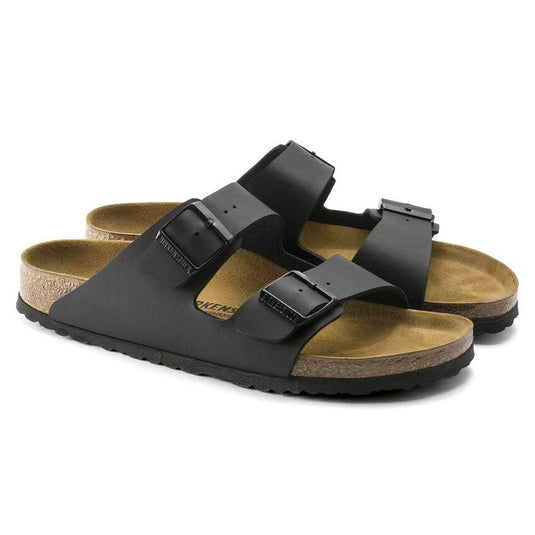 Black sandals with brown soles on a white background