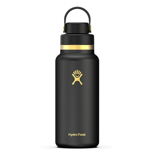Black Hydro Flask water bottle with gold lid on a white background