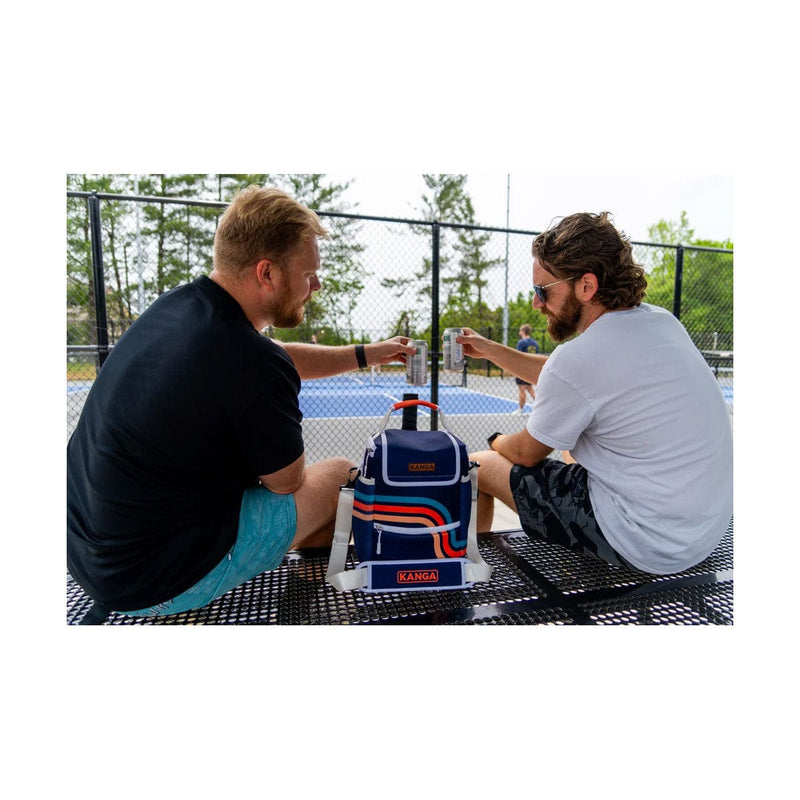 Load image into Gallery viewer, Two men sitting at a table with a cooler labeled 'Kona' on a tennis court.