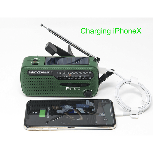 Green portable radio with charging cable for iPhone X on a white background