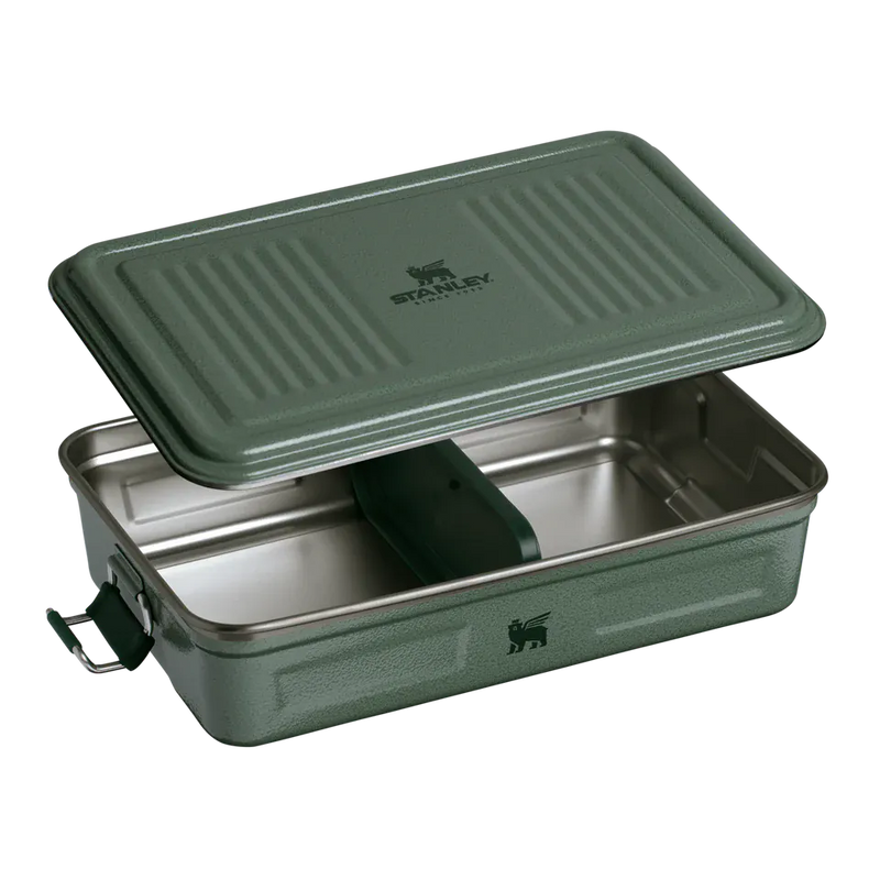 Load image into Gallery viewer, A green Stanley food storage container with its lid propped open, showing a stainless steel interior and a dark green divider, on a white background.