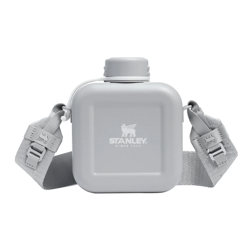Load image into Gallery viewer, Gray water bottle with strap featuring Stanley logo on a white background