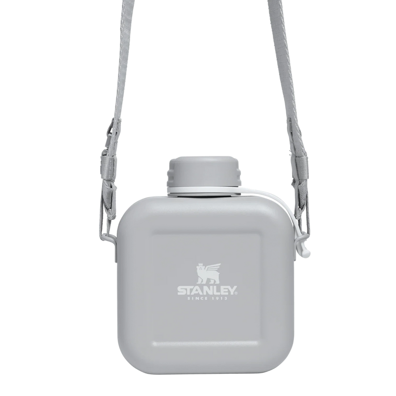 Load image into Gallery viewer, Gray water bottle with shoulder strap on a white background, featuring Stanley logo.