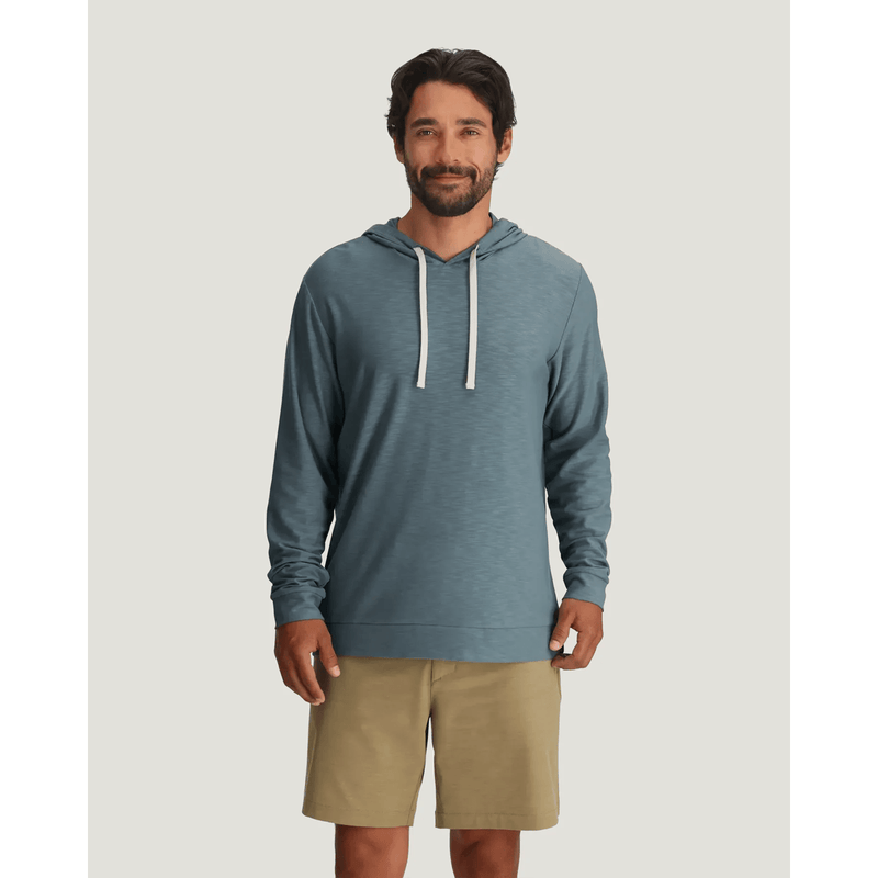 Load image into Gallery viewer, Man wearing a blue hoodie and beige shorts on a light gray background