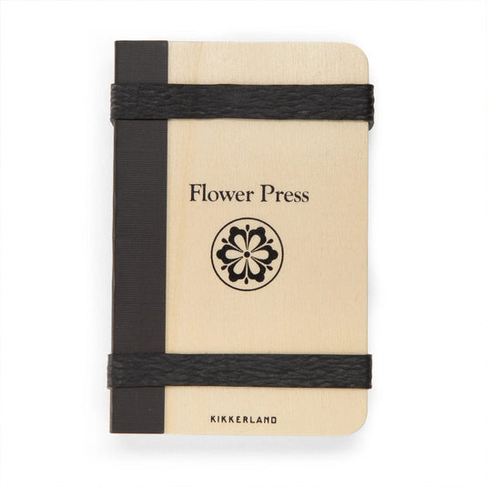 Small notebook with 'Flower Press' and 'Kikkerland' branding on a white background
