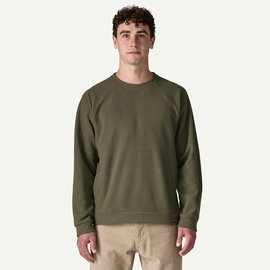 Man wearing an olive green sweatshirt on a white background