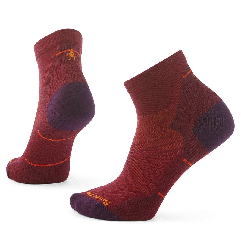 Load image into Gallery viewer, A pair of Smartwool women's run zero cushion ankle socks in red color with purple and orange accents.