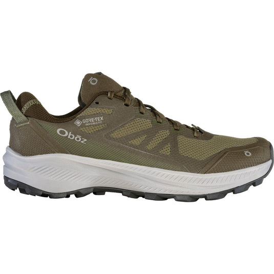 Green hiking shoe with white sole on a white background