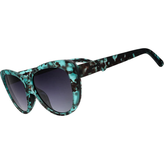 Sunglasses with teal and black patterned frame on a white background