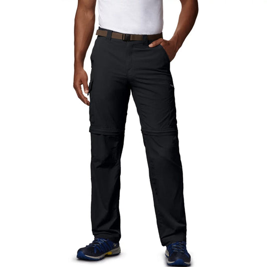 Black pants worn by a person on a white background