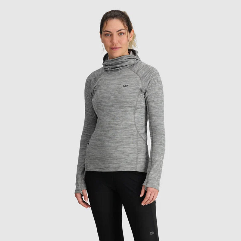 Load image into Gallery viewer, A woman wearing a gray Outdoor Research fleece pullover hoodie with a high neck, long sleeves, and black pants.
