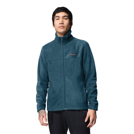 Person wearing a teal fleece jacket with Columbia logo on a white background