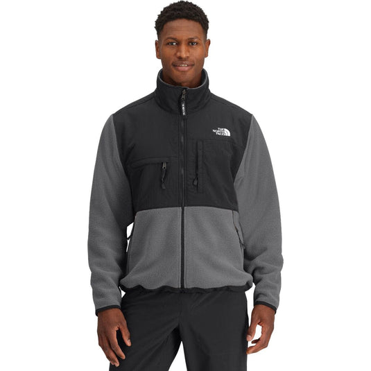Man wearing a two-tone jacket with The North Face logo on a white background