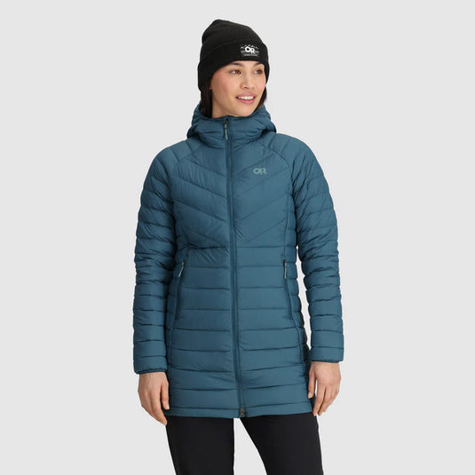 A woman wearing a blue Outdoor Research down parka with a hood, featuring a snug fit and insulated design.