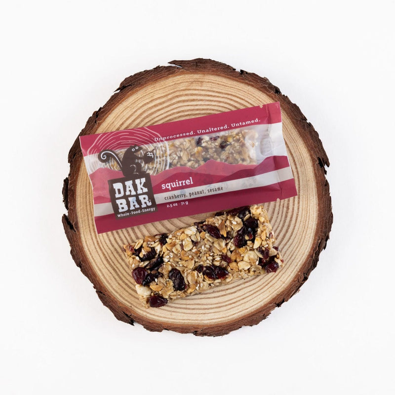 Load image into Gallery viewer, Dak Bar squirrel snack on a wooden log with packaging