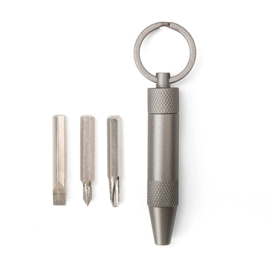 Metal keychain tool with interchangeable bits on a white background