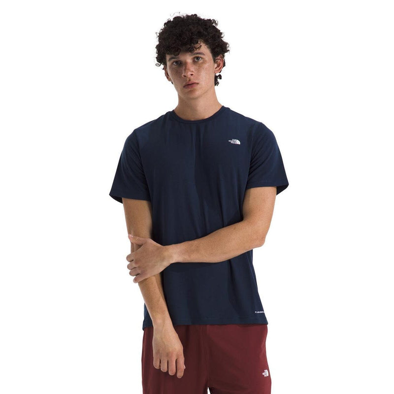 Load image into Gallery viewer, Person wearing a navy blue t-shirt with a logo on a white background