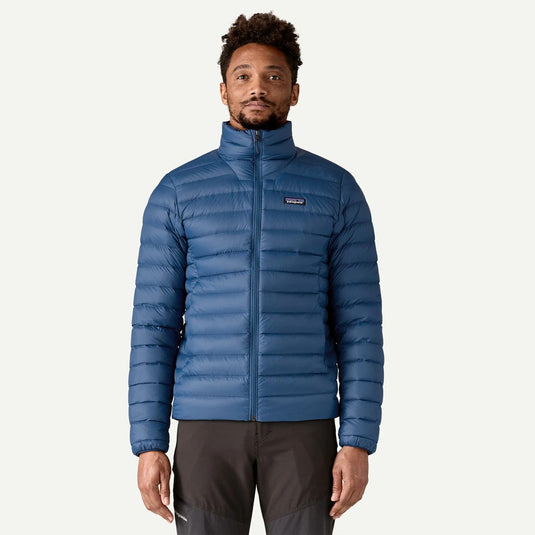 Man wearing a blue puffer jacket on a white background