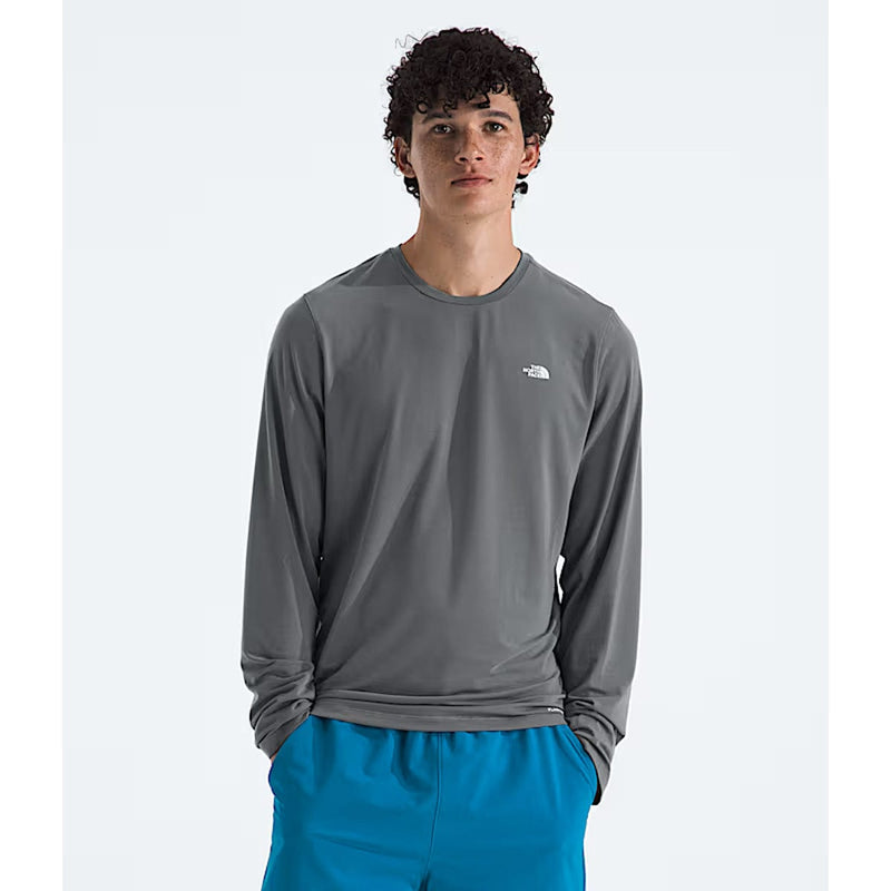 Load image into Gallery viewer, Person wearing a gray long-sleeve shirt with a logo and blue shorts on a white background