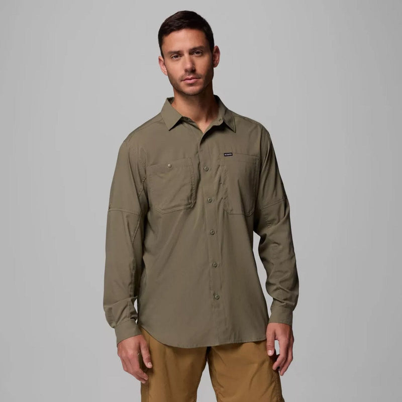 Load image into Gallery viewer, Man wearing a green shirt with a logo on a gray background