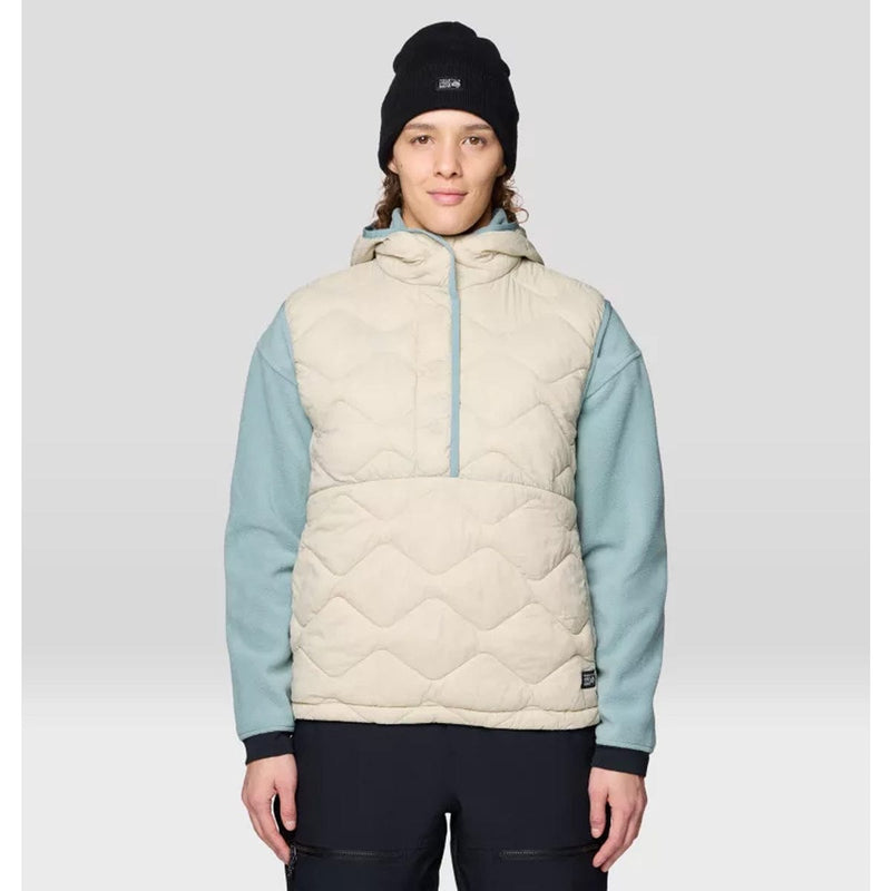 Load image into Gallery viewer, Person wearing a quilted vest with light blue sleeves and a black beanie on a gray background