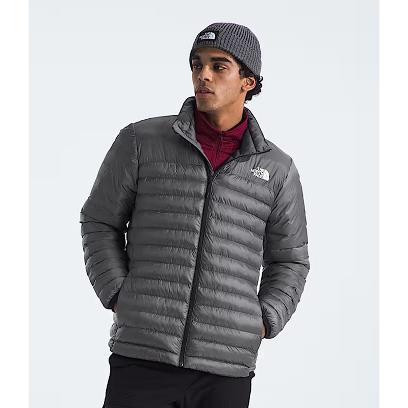 Load image into Gallery viewer, Person wearing a gray puffer jacket and beanie with The North Face logo on a white background