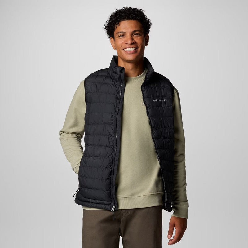 Load image into Gallery viewer, Man wearing a black puffer vest over a green sweater on a white background
