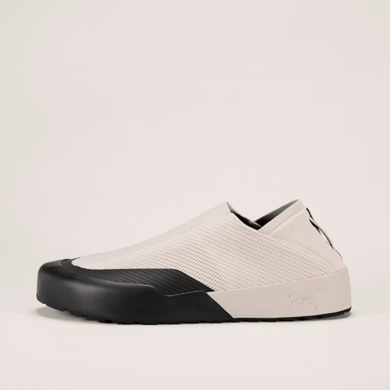 Load image into Gallery viewer, White slip-on shoe with black sole on a light beige background