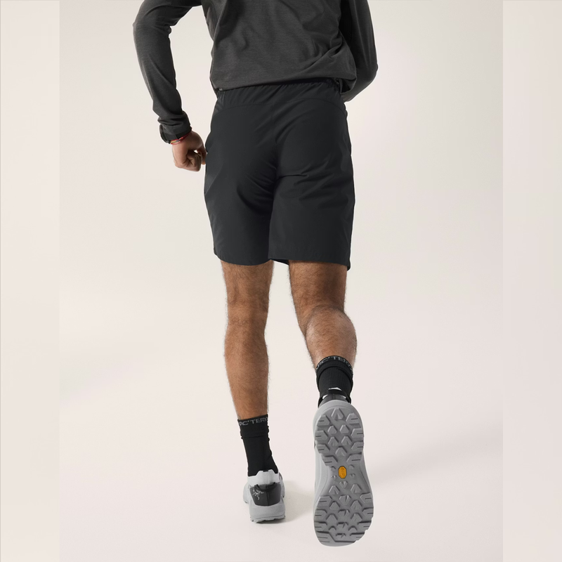 Load image into Gallery viewer, Person wearing black athletic shorts and shoes on a light gray background
