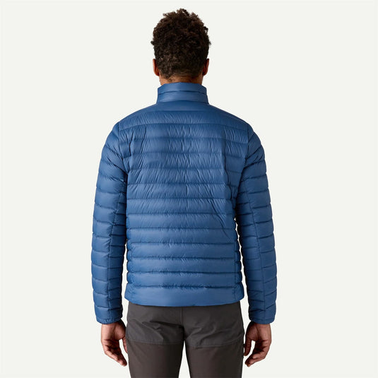 Person wearing a blue puffer jacket on a white background