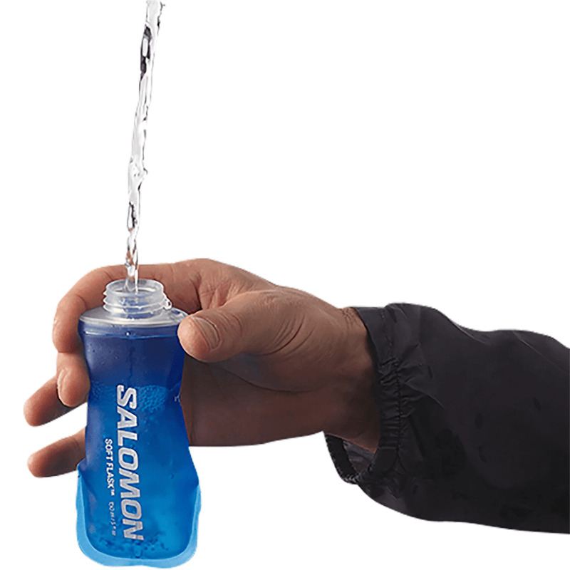 Load image into Gallery viewer, Hand holding a blue Salomon soft flask with water being poured.