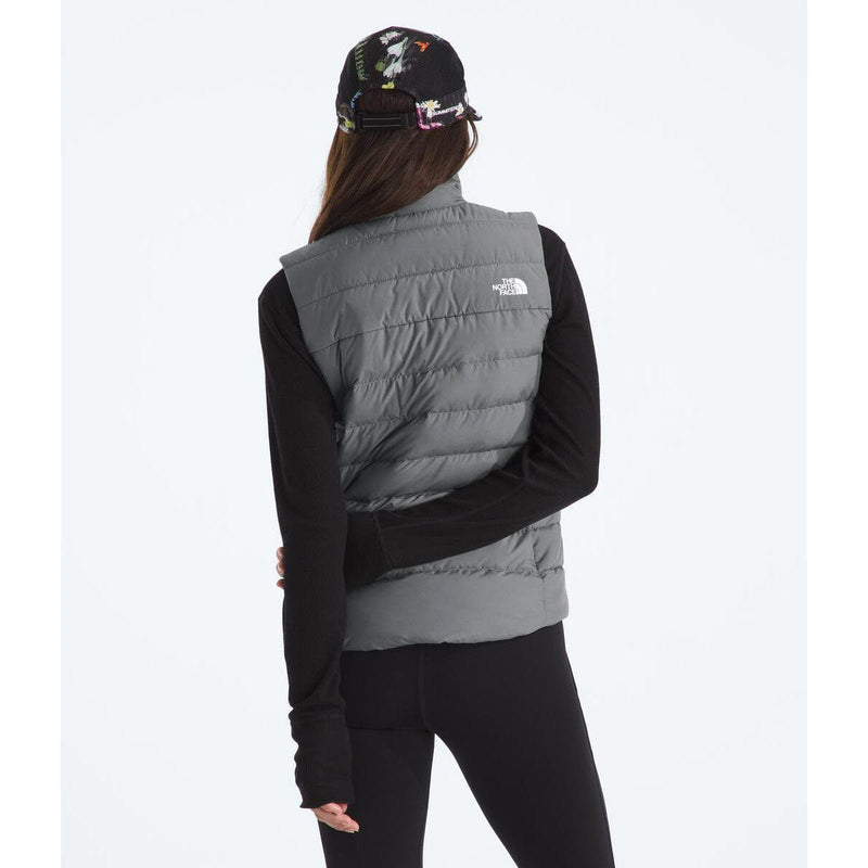 Load image into Gallery viewer, Person wearing a gray puffer vest with a visible brand logo on a white background