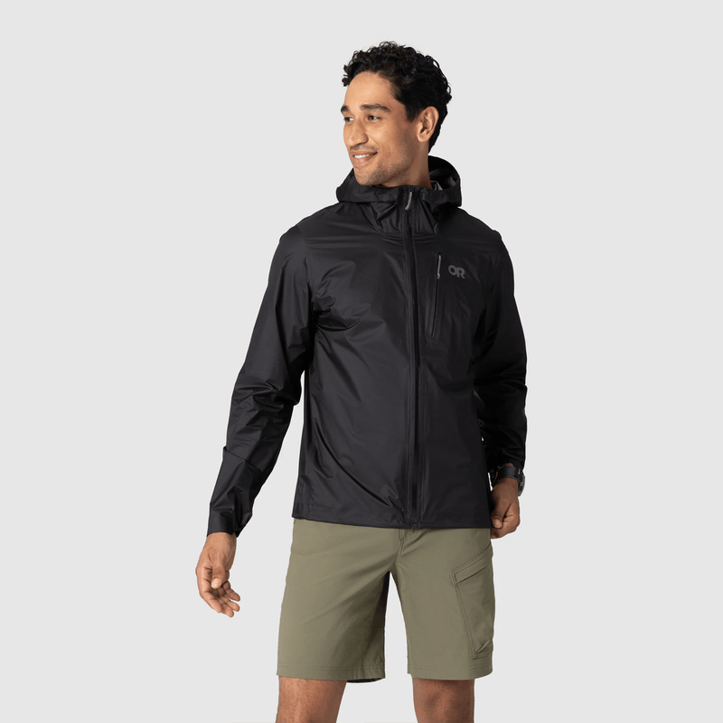 Load image into Gallery viewer, Man wearing a black jacket and green shorts on a light gray background