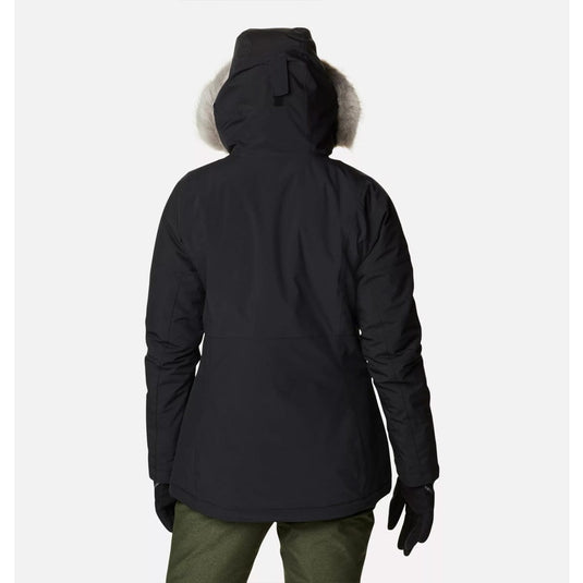 Person wearing a black winter jacket with fur hood on a white background