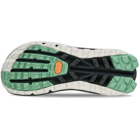 Close-up of a shoe sole with green and black pattern on a white background