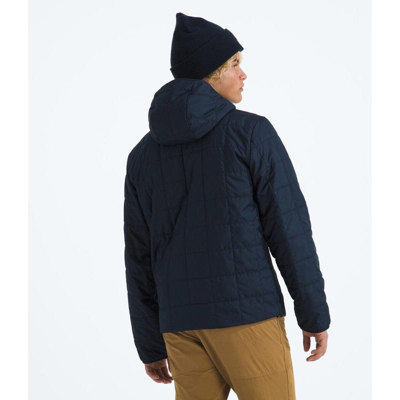 Load image into Gallery viewer, Person wearing a dark blue puffer jacket and black beanie on a white background