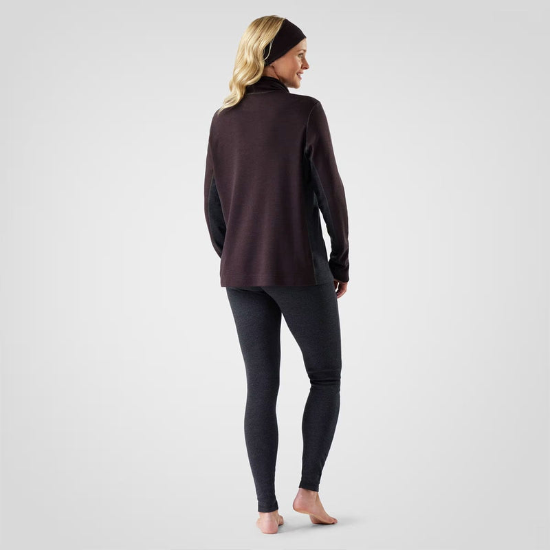 Load image into Gallery viewer, Woman wearing a dark long-sleeve top and leggings on a light gray background