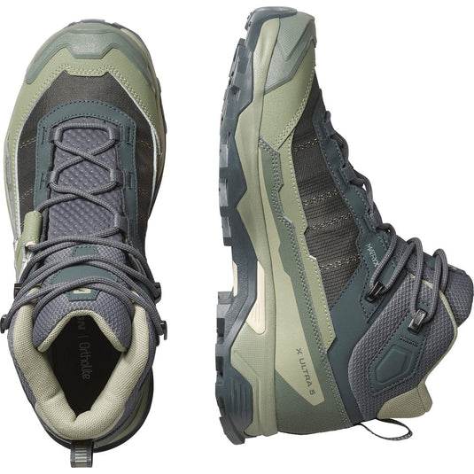 Pair of green and gray hiking boots on a white background