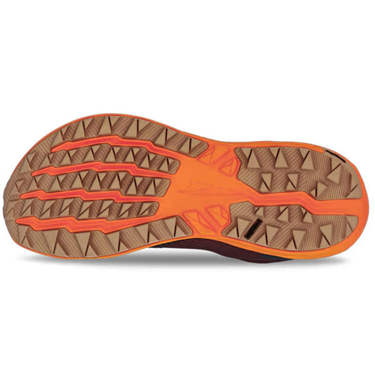 Close-up of a shoe sole with orange and brown tread pattern on a white background