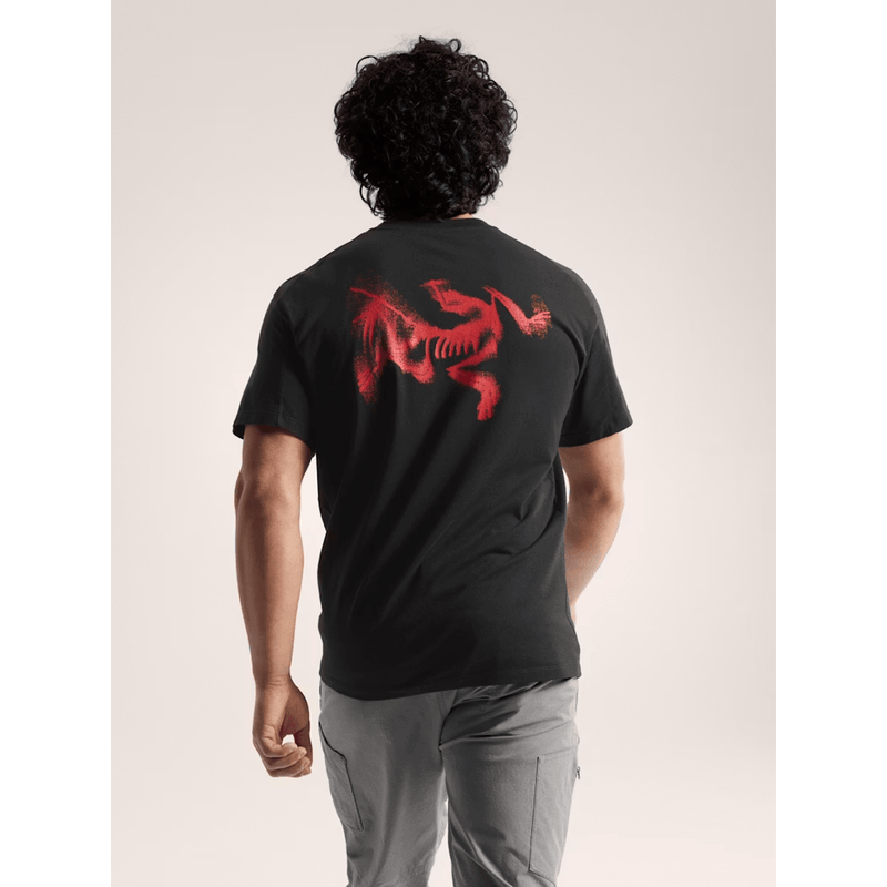 Load image into Gallery viewer, Person wearing a black t-shirt with a red graphic on the back against a neutral background