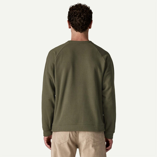 Person wearing a green sweatshirt on a white background