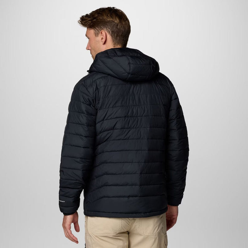 Load image into Gallery viewer, Man wearing a black puffer jacket on a light gray background