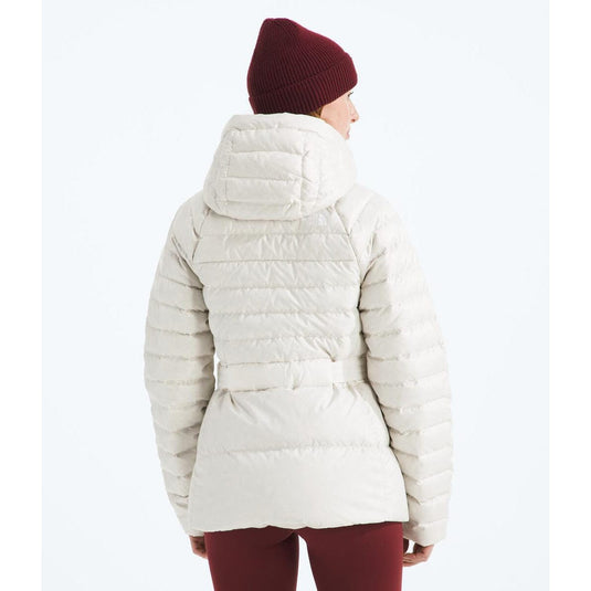 Person wearing a white puffer jacket and red beanie on a white background